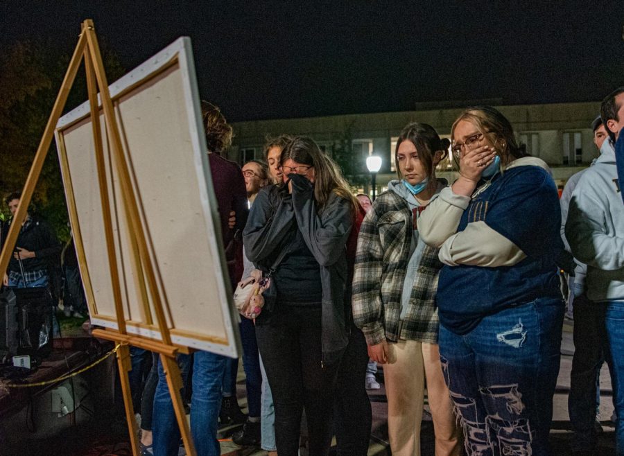 A group of vigil attendees mourn the lost of Jacob Jurinek. Jurinek, a SIU student, who was among the victims of the Astroworld festival tragedy on Nov. 5 in Houston on Monday, Nov. 8, 2021 at Faner Plaza at SIU in Carbondale, Illinois.