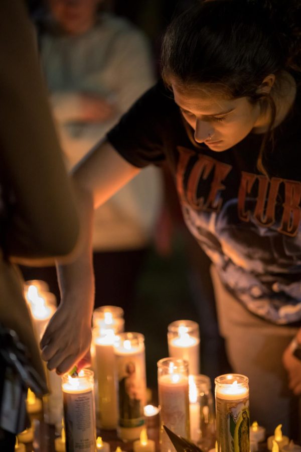 A student lights a candle at the vigil for Jacob Jurinek Monday, Nov. 8, 2021 at Faner Plaza in Carbondale, Illinois. Jurinek tragically passed away at the Astroworld Festival Friday, Nov. 5, 2021. 
