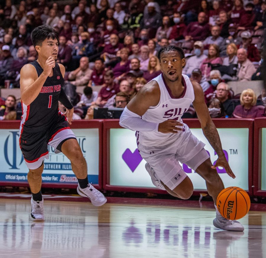 SIU guard, Lance Jones, drives the ball while being defended by Austin Peays Carlos Paez during SIUs 73-55 win over Austin Peay during the Charles Helleny Tip-Off Classic on Friday, Nov. 12, 2021 at the Banterra Center at SIU. 