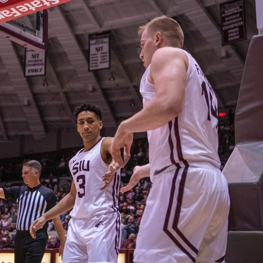 SIU guard Dalton Banks, left, goes in for a low-five with teammate Kyler Filewich, after he got fouled and prepares for a free throw attempt  during SIUs 73-55 win over Austin Peay during the Charles Helleny Tip-Off Classic on Friday, Nov. 12, 2021 at the Banterra Center at SIU. 