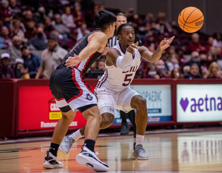 SIU guard, Lance Jones, passes the ball during a drive during SIUs 73-55 win over Austin Peay during the Charles Helleny Tip-Off Classic on Friday, Nov. 12, 2021 at the Banterra Center at SIU. 