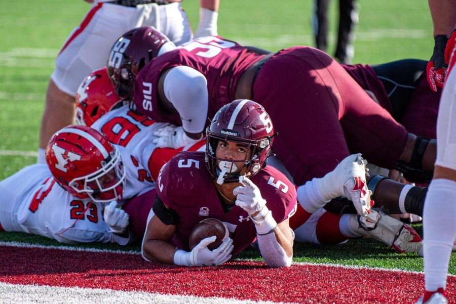SIU running back, Justin Strong, lays at the bottom of a dogpile after successfully completing a 2-point conversion during SIUs 18-35 loss vs. Youngstown State during Senior Day Saturday, Nov. 20, 2021 at Saluki Stadium at SIU.  