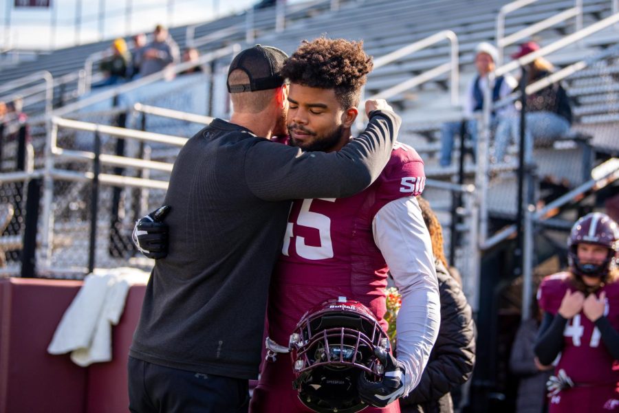 Senior defensive end, Raquan Lindsey, embraces head coach Nick Hill during the pregame ceremony on Senior Day before SIUs 18-35 loss vs. Youngstown State on Saturday, Nov. 20, 2021 at Saluki Stadium at SIU.   