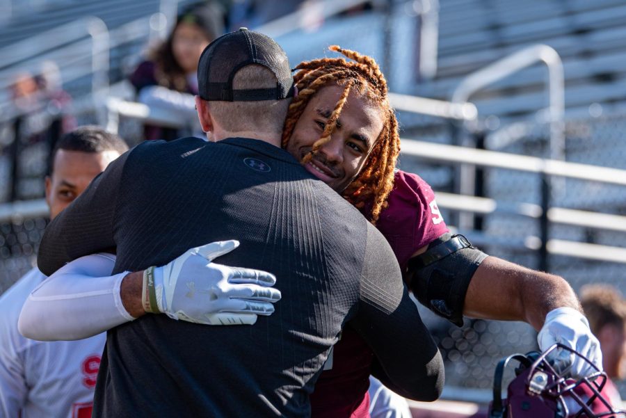 SIU senior linebacker, Bryce Notree, embraces head coach Nick Hill during the pregame ceremony on Senior Day before SIUs 18-35 loss vs. Youngstown State on Saturday, Nov. 20, 2021 at Saluki Stadium at SIU.   
