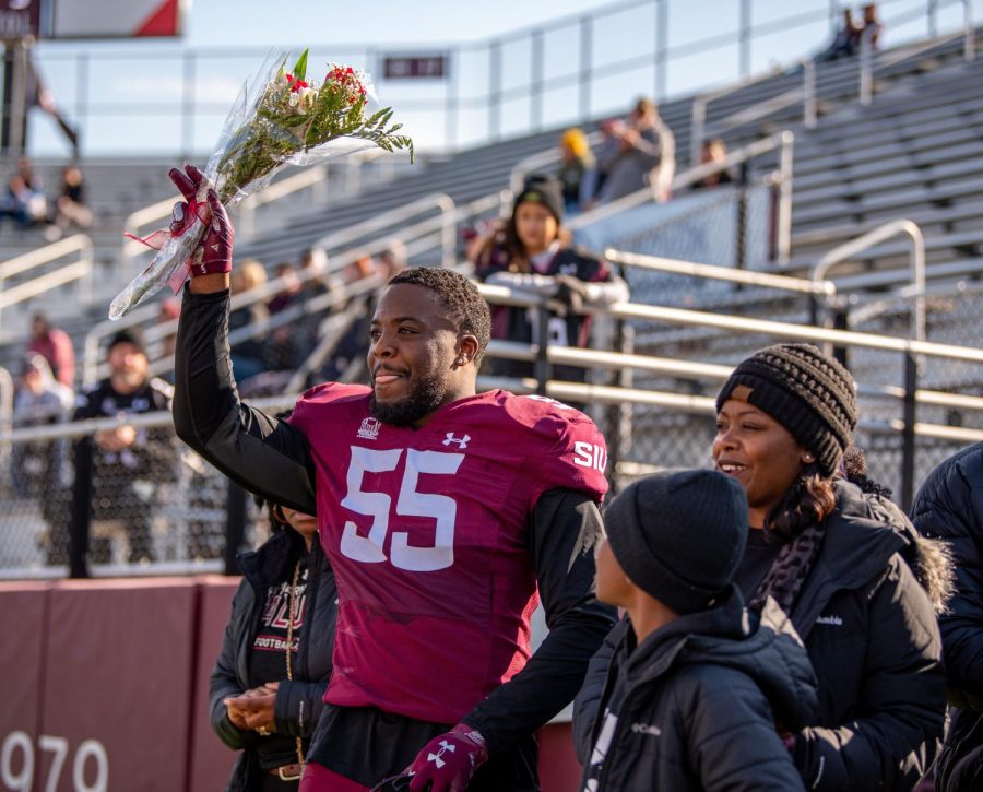 Senior linebacker, Kholbe Coleman, salutes the crowd as he walks out during the pregame ceremony on Senior Day before SIUs 18-35 loss vs. Youngstown State on Saturday, Nov. 20, 2021 at Saluki Stadium at SIU.   