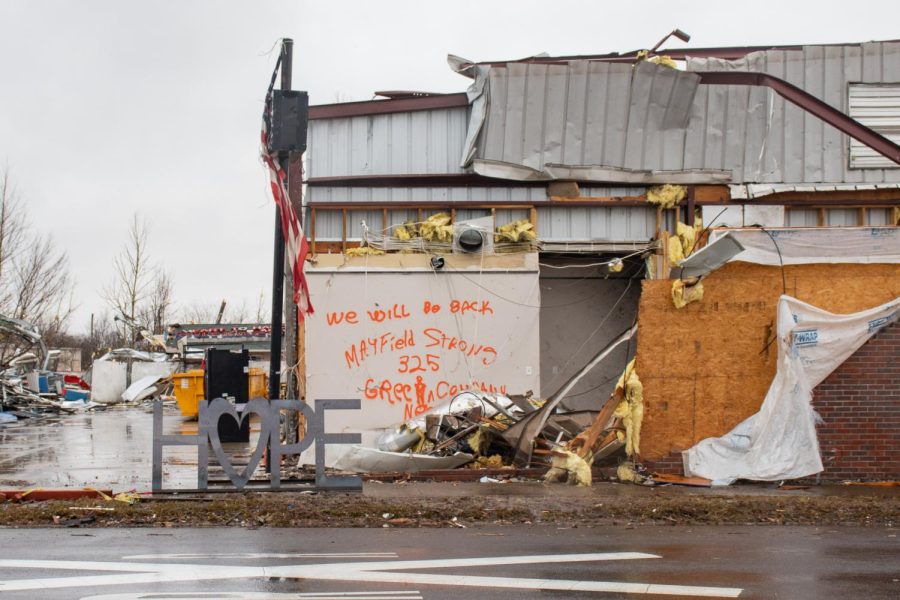 A sign that says, Hope sits in front of a demolished building that has we will be back and Mayfield Strong painted on one of the walls Dec. 18, 2021 in Mayfield, Kentucky.  