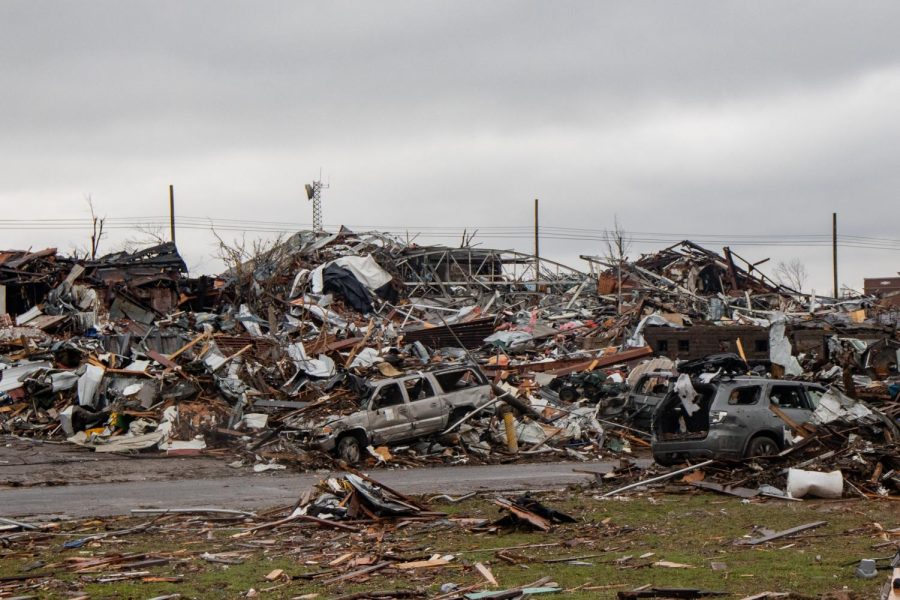 Debris from the Dec. 10 tornado piles on top of cars and the remains of buildings Dec. 18, 2021 in Mayfield, Kentucky. 