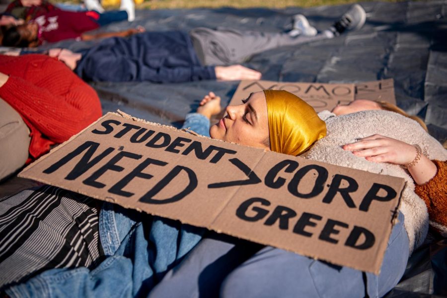 SIU student, Kat McCauley, lies with the group of protesters in the die-in during the protest held by SIU Student Safety Initiative on Dec. 1, 2021 at SIU.  