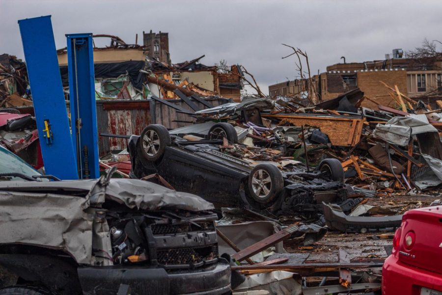 Upturned car rest among other demolished cars and debris of nearby buildings Dec. 18, 2021 in Mayfield, Kentucky.