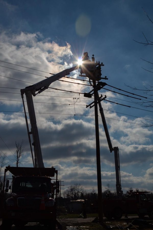 Lineman from Tupelo, Mississippi repair damaged electrical lines Dec. 19, 2021 in Mayfield, Kentucky.