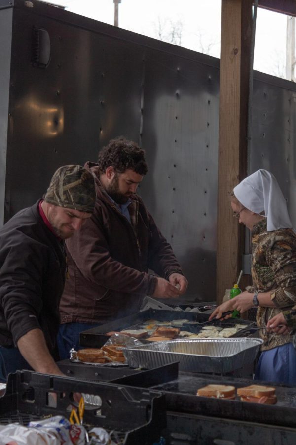 Volunteers cook food to feed community members at the Mayfield-Graves Fairgrounds Dec. 19, 2021 in Mayfield, Kentucky.
