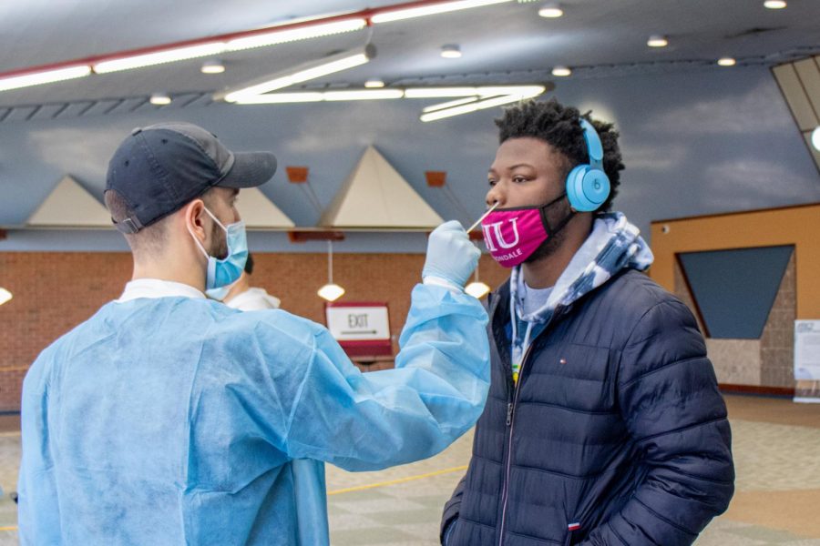 SIU student helps stop the spread of coronavirus by getting a COVID-19 test Jan. 12, 2022 at Grinnell Hall in Carbondale, Ill. SIU mandated all returning students and faculty to receive a COVID-19 test in order to regulate positive cases. 
