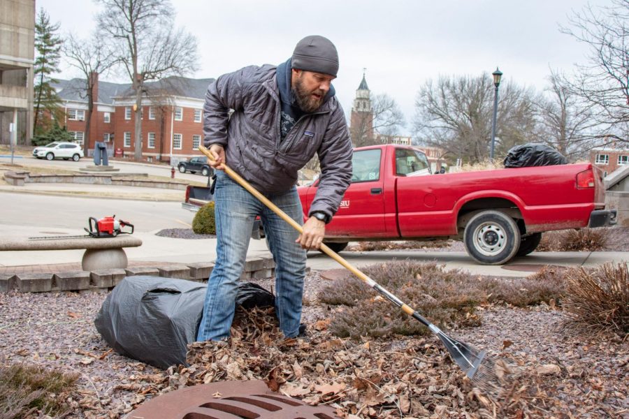Ryan Hagler, an SIU grounds keeper, rakes leaves into a garbage bag Jan. 24, 2022 at SIU in Carbondale, Ill. Hagler has been working with the school since 2004. 
