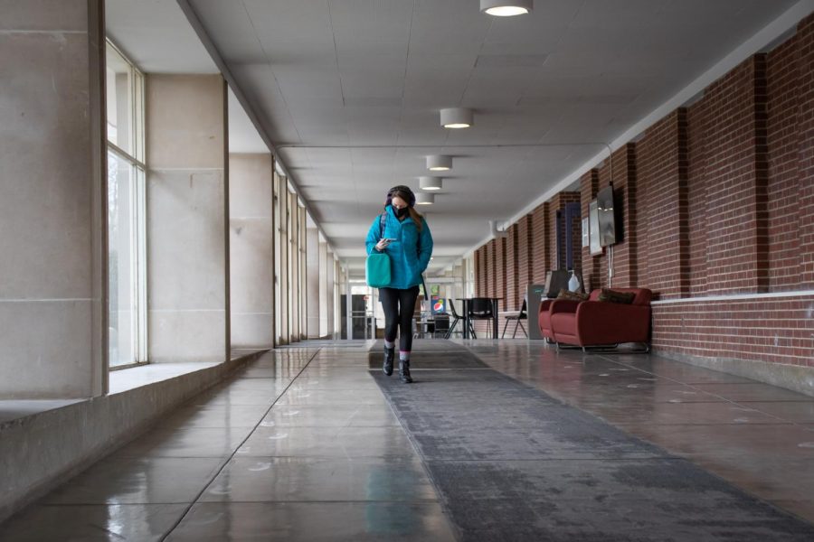 Morgan Kruse walks in the hallway between Wham and Pulliam Jan. 24, 2022 at SIU in Carbondale, Ill. Kruse graduated with a bachelors degree from SIU in May and has now returned as a graduate student studying outdoor recreation. 