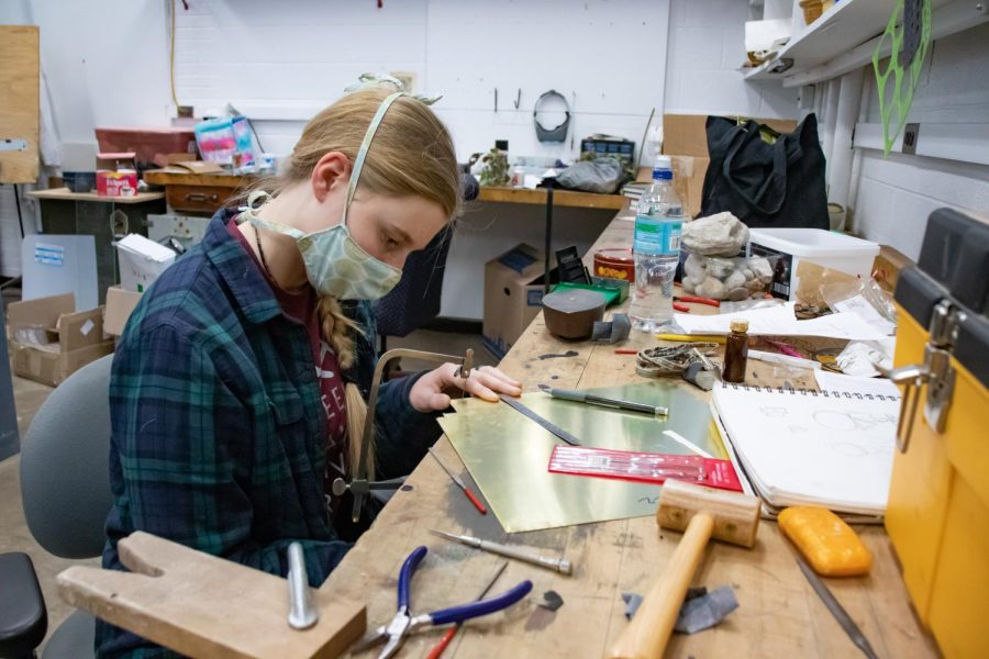 SIU metal smithing and black smithing student, Alydia Downs, works on a project Jan. 24, 2022 at SIU in Carbondale, Ill. 