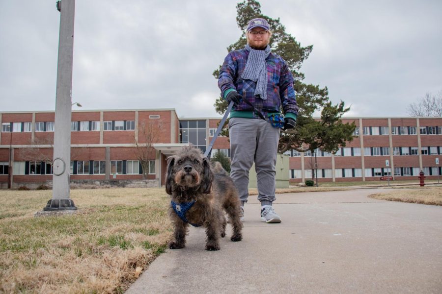 Drake Martin, a junior at SIU, walks his dog, Scruffy, on campus Jan. 24, 2022 at SIU in Carbondale, Ill. 