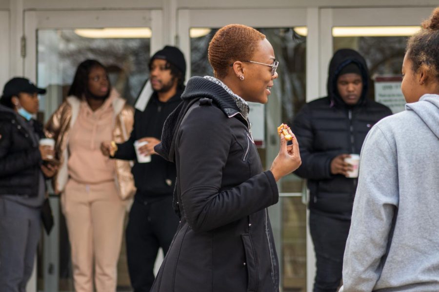 SIU students eat donuts and drink hot chocolate in front of Grinnell Hall  to celebrate the late civil rights activist Dr. Martin Luther King Jr. Jan. 17, 2022 in Carbondale, Ill.