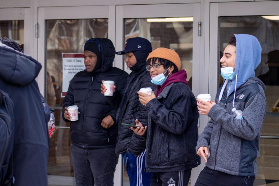 SIU students drink their hot chocolate while they listen to the speakers from Alpha Phi Alpha Fraternity at the MLK Day March Jan. 17, 2022 in Carbondale, Ill.
