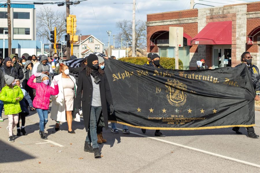 Alpha Phi Alpha Fraternity members march down South University Avenue  to honor the life and legacy of Dr. Martin Luther King Jr. Jan. 17, 2022 in Carbondale, Ill. 

