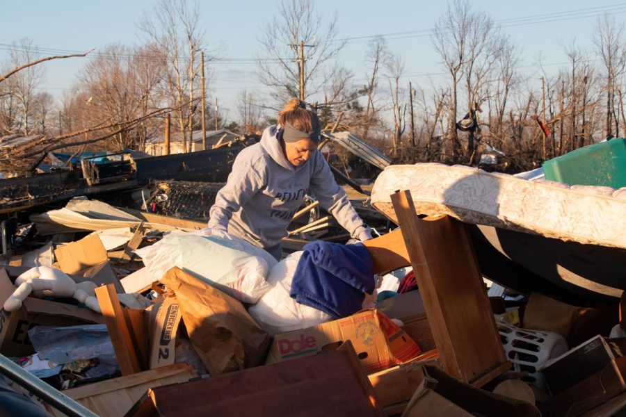 Cheryl Vincent looks through piles of debris from the Dec. 10 tornado in search of her possessions Dec. 19, 2021 in Dawson Springs, Kentucky. 