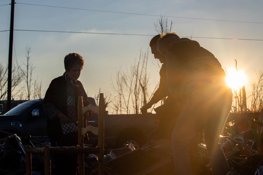 The Tolbert family uncovers Marvalyn Tolberts grandmothers lost tea kettle as the sun sets on the last day they can search for belongings in a tornado-damaged storage unit Dec. 19, 2021 in Dawson Springs, Kentucky. 