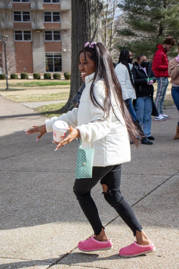 An MLK Day March participant dances with a friend before the march Jan. 17, 2022 in Carbondale, Ill. 