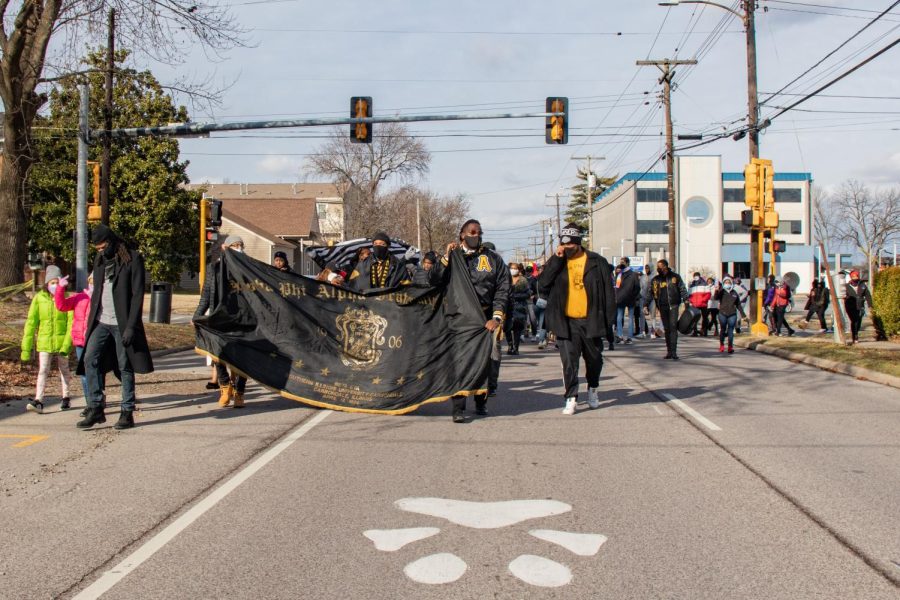 Marchers in the Alpha Phi Alpha Fraternity Inc. MLK Day March walk down University Avenue Jan. 17, 2022 in Carbondale, Ill. 