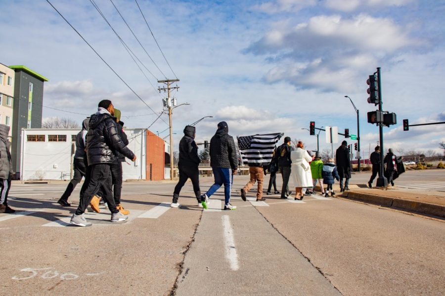 Participants in the Alpha Phi Alpha Fraternity Inc. MLK Day March cross the street Jan. 17, 2022 in Carbondale, Ill. 