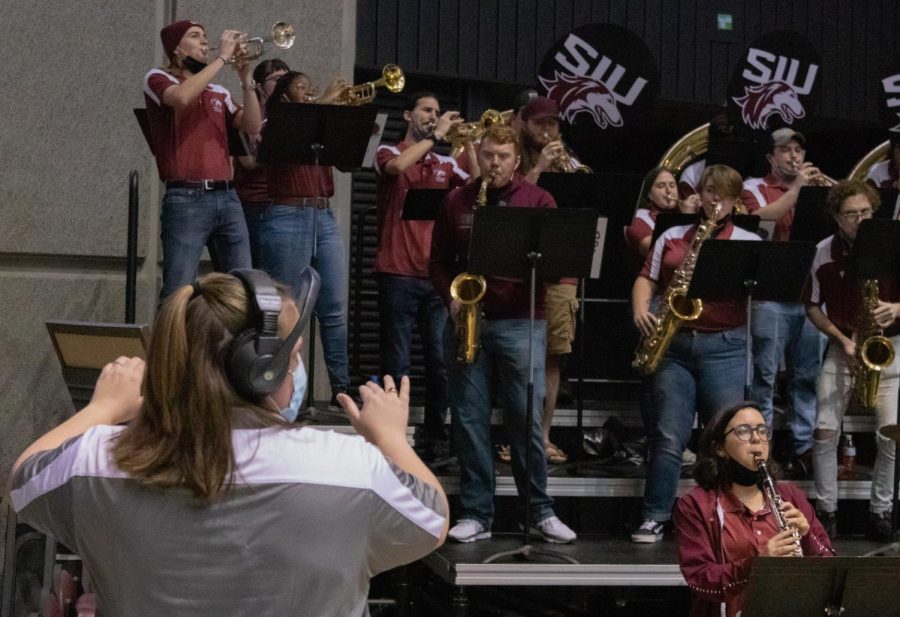 SIU graduate student, Rachelle Bartleman, directs the SIU Pep Band at the Dawg Pound Maroon Madness Pep Rally Jan. 13, 2022 at the Banterra Center in Carbondale, Ill.
