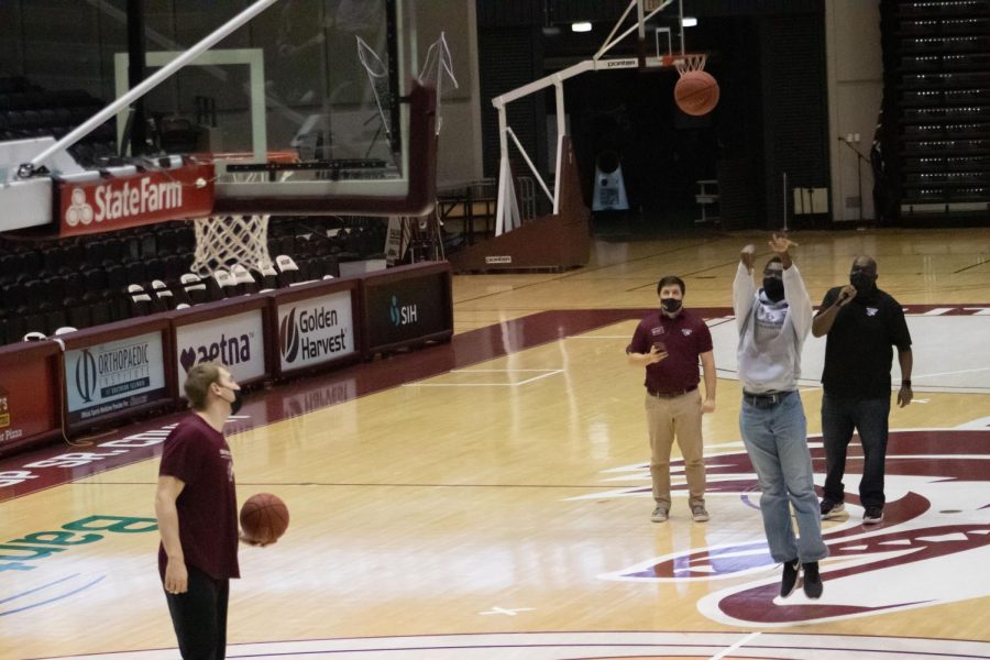 A student participant shoots a basketball during a game against an SIU basketball player at the Dawg Pound Maroon Madness Pep Rally Jan. 13, 2022 at the Banterra Center in Carbondale, Ill. 
