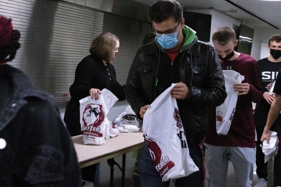 Students look through goodie bags that were given out after the pep rally at the Dawg Pound Maroon Madness Pep Rally Jan. 13, 2022 at the Banterra Center in Carbondale, Ill.
