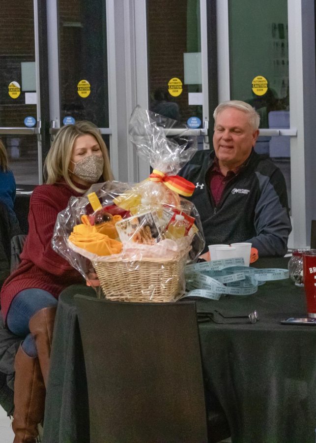 Tami Hansbrough (left) wins a gift basket from a raffle at the SIU softball fundraising dinner Jan. 22, 2022 at the Banterra Center in Carbondale, Ill. 
