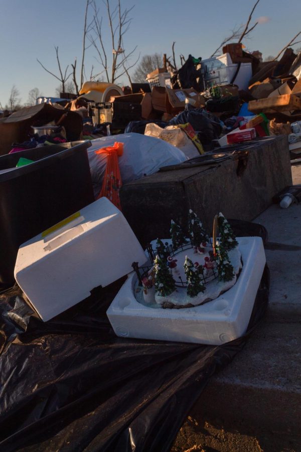 A Christmas decoration sits among the scattered belongings of multiple individuals Dec. 19, 2021 in Dawson Springs, Ky.