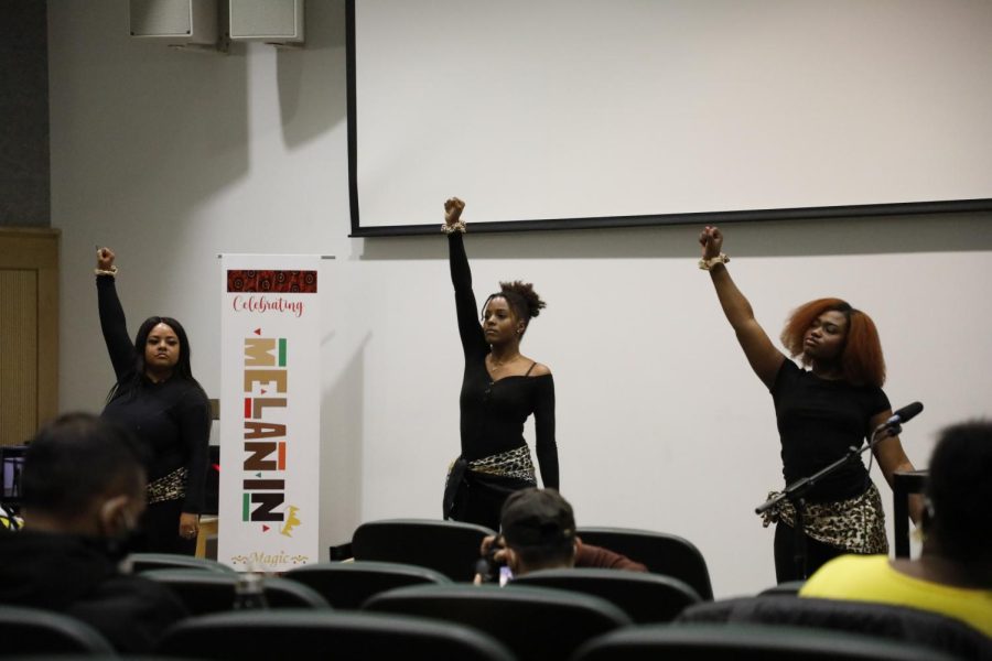 Members of the Epsilon Chapter of Delta Phi Delta Dance Sorority raise their fists in the air during their dance performance at the Afro-Centric Fashion Show on Feb. 27, 2022 in Guyron Auditorium in Carbondale, Ill. 
