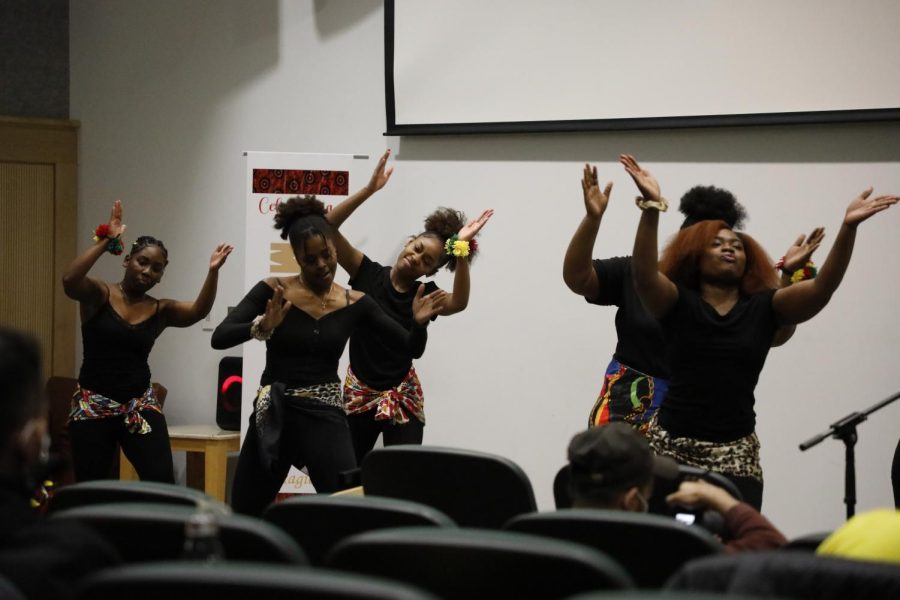 Members of SIU’s Delta Phi Delta Dance Sorority dance while the fashion show contestants change into their “Celebrating Our Melanin” inspired attire on Feb. 27, 2022 at Morris Library in Carbondale, Ill. 

