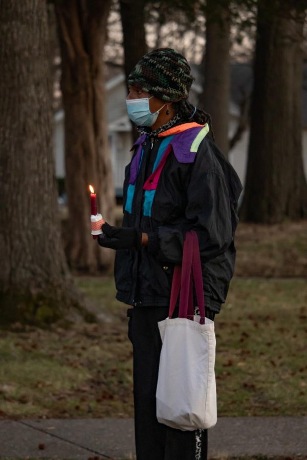 A participant at the Amir Locke protest holds a candle in his memory Feb. 27, 2022 at Turley Park in Carbondale, Ill. 
