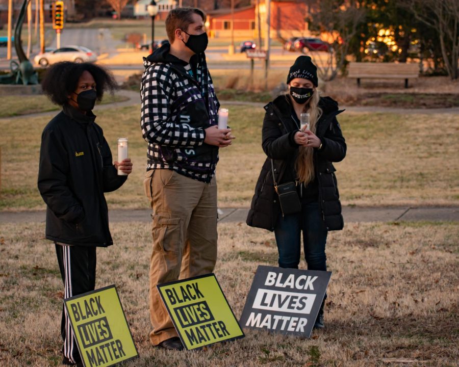 Protestors stand with “Black Lives Matter” signs on Feb. 27, 2022 for a protest on the removal of no-knock warrants and the death of Amir Lock at Lenus Park in Carbondale, Ill.
