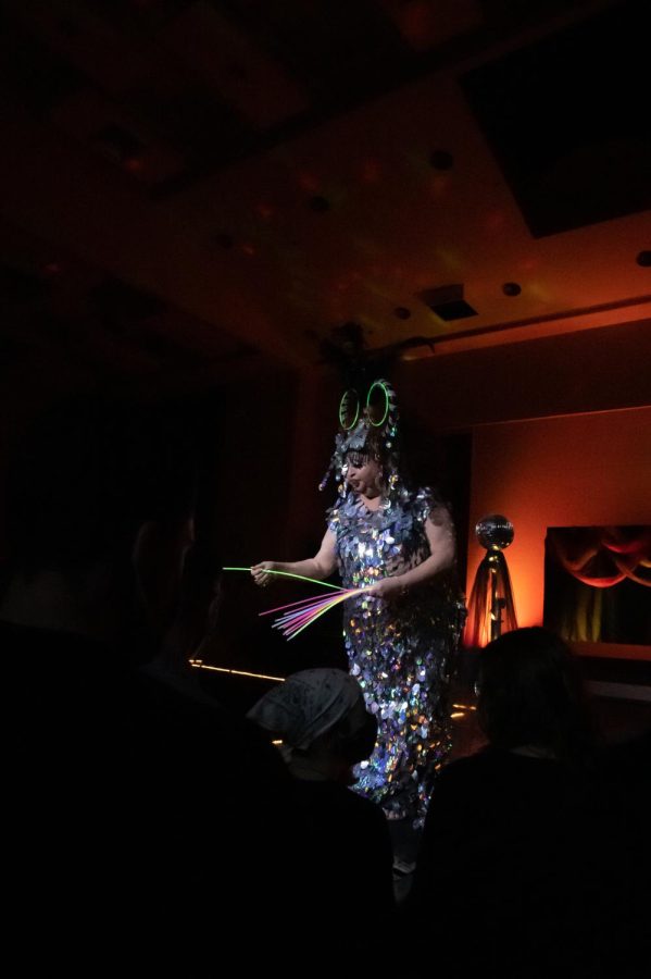 Blanche DuBois hands out glow sticks as part of her act at the Spicy Seventies Disco Drag Show, which was cosponsored by the Saluki Rainbow Network and the Office of Student Engagement, Feb. 19, 2022 at the SIU Student Center in Carbondale, Ill. 