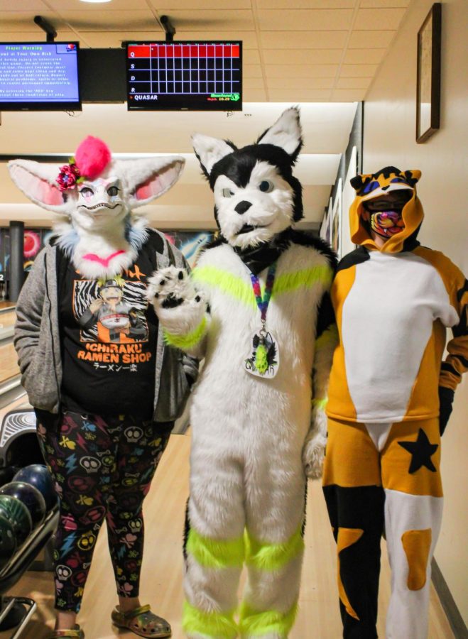 Two members of the Saluki Furry Society stand next to founder Tyler Knupp (middle) before the “Furbowl event in the Student Center bowling alley Feb. 27, 2022 at SIU in Carbondale, Ill. “I started this club my freshman year, in spring 2018,” Knupp said.

