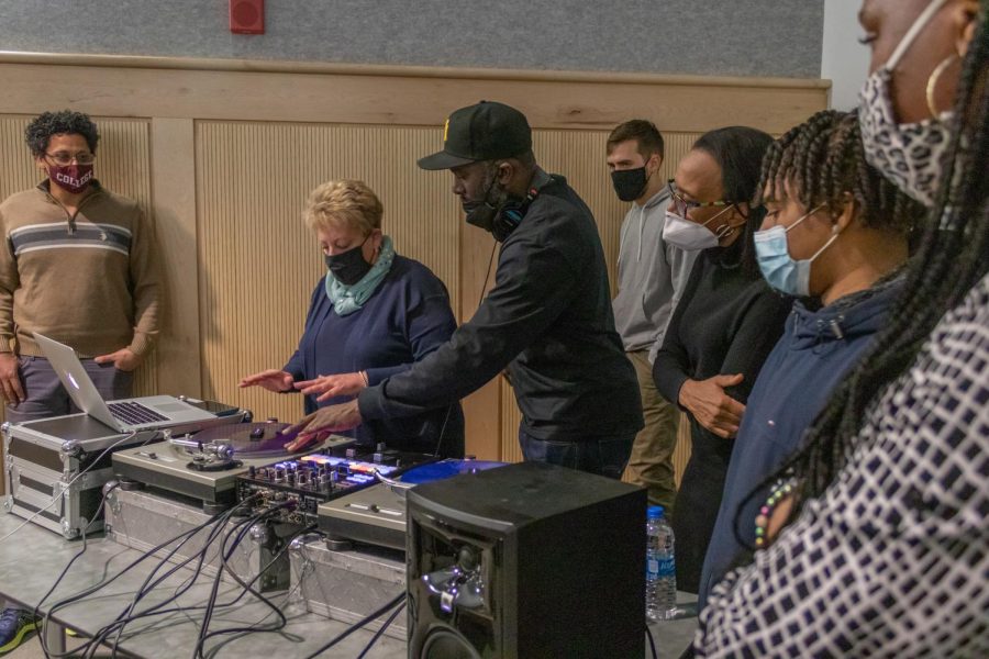Richard Jones Jr., DJ at the Understanding Hip-Hop Culture seminar, shows attendees how to scratch on a turntable Feb. 8, 2022 at the Guyon Auditorium in Carbondale, Ill. 
