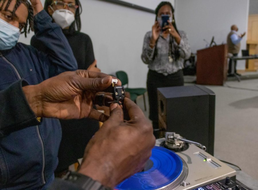 Richard Jones Jr., DJ at the Understanding Hip-Hop Culture seminar, shows needle equipment for a turntable Feb. 8, 2022 at the Guyon Auditorium in Carbondale, Ill.
