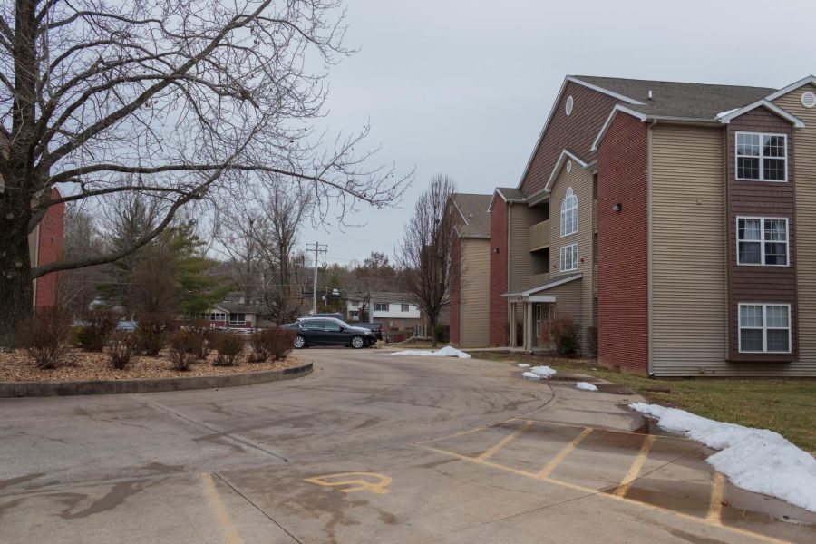 Cars sit in a parking lot in front of an apartment building Feb. 12, 2022 at the Pointe in Carbondale, Ill. 
