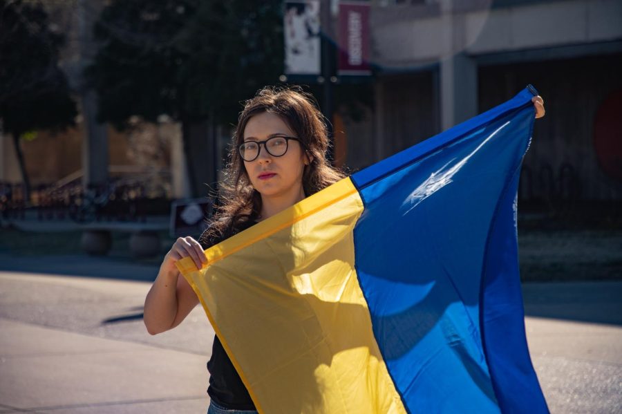 Diana Butsko, a Ukrainian masters student at SIU, holds up a Ukrainian flag March 2, 2022 in Carbondale, Ill. 