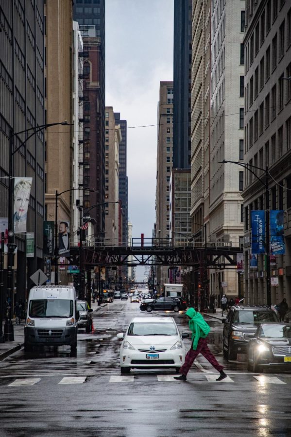 A man hurries through an intersection on Michigan Avenue to get out of the rain March 18, 2022 in Chicago, Ill. 