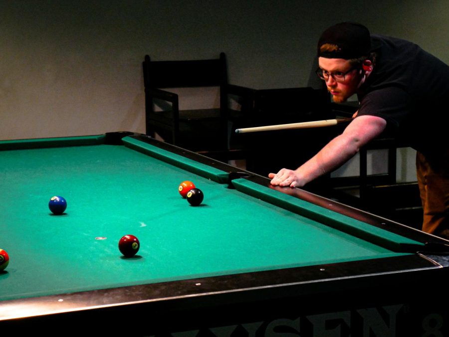 A man plays pool at the SIU Student Center Bowling and Billiards March 28, 2022 in Carbondale, Ill. 