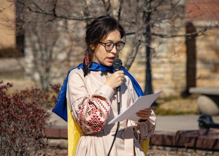 SIU Ukrainian international student, Diana Butsko, speaks at the Support Ukraine Rally with the Ukrainian flag draped over her shoulders on March 3, 2022 at Faner Plaza in Carbondale, Ill. 