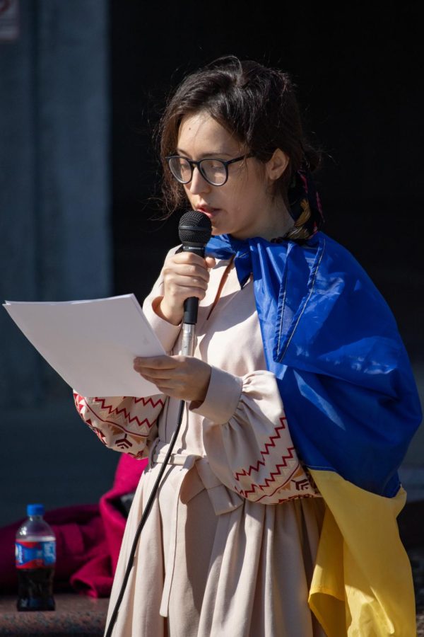 SIU Ukrainian student, Diana Butsko, speaks at the Support Ukraine Rally with the Ukrainian flag draped over her shoulders March 3, 2022 at Faner Plaza in Carbondale, Ill. 