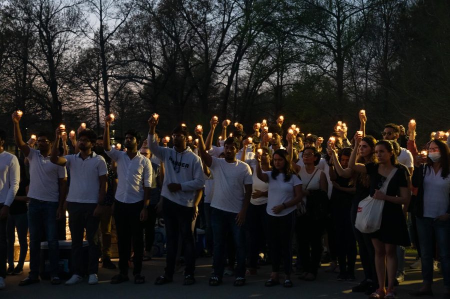 Students and community members raise a candle in memory of Vamshi Krishna Pechetty and Pavan Swarna April 22, 2022 at Becker Pavilion in Carbondale, Ill. 