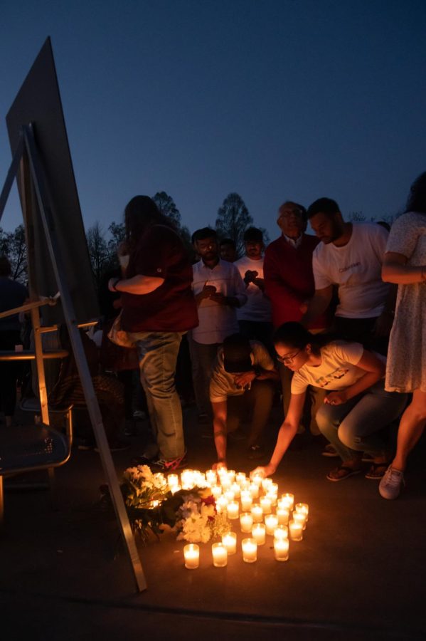 Community members bring light candles in memory of Vamshi Krishna Pechetty and Pavan Swarna, SIU graduate students who passed away in a car accident, April 22, 2022 at Becker Pavilion in Carbondale, Ill. 