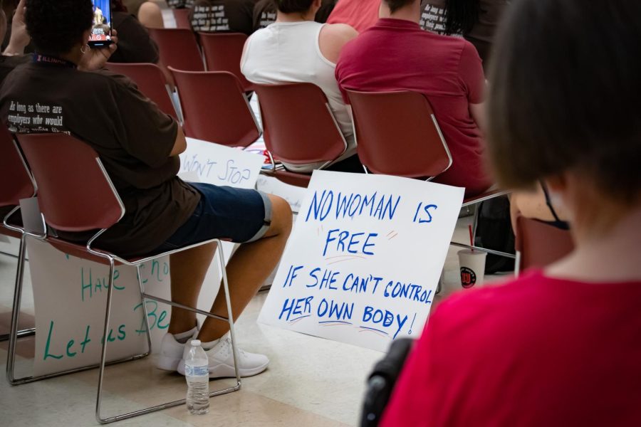 A poster sits on the floor saying, No Woman Is Free If She Cant Control Her Own Body! at the Bans Off Our Bodies March May 14, 2022 in Carbondale, Ill. 
